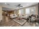 Bright living room featuring plantation shutters, ceiling fan and wood flooring at 10539 E Corbin Ave, Mesa, AZ 85212