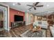 Open-concept living area with wood flooring, ceiling fan, and seamless flow to kitchen at 10539 E Corbin Ave, Mesa, AZ 85212