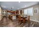 Open-concept room with dining table and modern kitchen island, and wood look flooring at 10539 E Corbin Ave, Mesa, AZ 85212