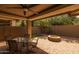 Cozy covered patio with outdoor seating and a brick fire pit for relaxing evenings at 10539 E Corbin Ave, Mesa, AZ 85212