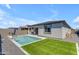 Spacious backyard features a pool, patio, green turf, and privacy landscaping at 11357 E Unger Ave, Mesa, AZ 85212