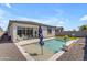 Inviting backyard oasis with a pool, patio, manicured lawn, and comfortable seating at 11357 E Unger Ave, Mesa, AZ 85212