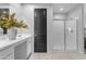 Modern bathroom with a sleek glass-enclosed shower, vanity with white countertop, and contemporary fixtures at 11357 E Unger Ave, Mesa, AZ 85212