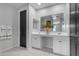 Bright bathroom featuring double sinks, large mirrors, white cabinets, and modern finishes at 11357 E Unger Ave, Mesa, AZ 85212