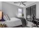 Bright bedroom with a comfortable bed, ceiling fan, closet, and a desk ideal for a home office at 11357 E Unger Ave, Mesa, AZ 85212