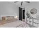 Bright bedroom featuring a comfortable bed, modern ceiling fan, and contemporary decor at 11357 E Unger Ave, Mesa, AZ 85212