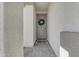 Charming entryway featuring a gray front door with a decorative wreath and a welcoming mat at 11357 E Unger Ave, Mesa, AZ 85212