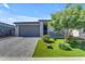 Charming single-story home featuring a low maintenance yard with a well-manicured tree and a paver driveway at 11357 E Unger Ave, Mesa, AZ 85212