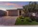 Charming single-story home featuring a low maintenance yard with a well-manicured tree and a paver driveway at 11357 E Unger Ave, Mesa, AZ 85212