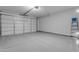 Clean garage showcasing sealed concrete floor, and well-maintained garage door at 11357 E Unger Ave, Mesa, AZ 85212