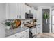Bright kitchen featuring white cabinets, stainless steel appliances, stylish countertops, and decorative accessories at 11357 E Unger Ave, Mesa, AZ 85212