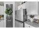 Modern kitchen with stainless steel refrigerator, white cabinets, and stylish decor at 11357 E Unger Ave, Mesa, AZ 85212