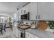 Modern kitchen with white cabinetry, stainless steel appliances, and countertops with stylish accessories at 11357 E Unger Ave, Mesa, AZ 85212