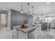 Contemporary kitchen island with stainless steel dishwasher and pendant lighting at 11357 E Unger Ave, Mesa, AZ 85212