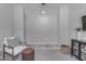 Cozy living room featuring a chair, leather ottoman, and modern entertainment center at 11357 E Unger Ave, Mesa, AZ 85212