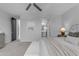 Bright main bedroom featuring plush carpet, ceiling fan, and ensuite bathroom, all bathed in natural light at 11357 E Unger Ave, Mesa, AZ 85212