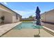Backyard pool with clear water, sun umbrella, and view of the well-maintained backyard at 11357 E Unger Ave, Mesa, AZ 85212