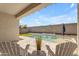 Backyard pool and patio area featuring turf, pool with waterfall and lounge chairs at 11357 E Unger Ave, Mesa, AZ 85212