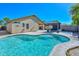 Backyard oasis with a sparkling pool and a covered patio area at 13349 W Boca Raton Rd, Surprise, AZ 85379