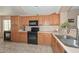Spacious kitchen with dark appliances and tile floors at 13349 W Boca Raton Rd, Surprise, AZ 85379