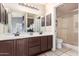 Neutral bathroom with double sink vanity, large mirror, and walk-in shower with glass doors at 14216 N Saguaro Blvd # A, Fountain Hills, AZ 85268