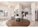 Open-concept dining area flows into the kitchen, featuring a round table, tiled floors, and ample natural light at 14216 N Saguaro Blvd # A, Fountain Hills, AZ 85268