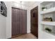 Hallway with built in shelving, light walls, and a closet with brown sliding doors at 14216 N Saguaro Blvd # A, Fountain Hills, AZ 85268