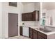 Kitchen showcasing modern sink, dark wood cabinets, and white appliances in a neutral color palette at 14216 N Saguaro Blvd # A, Fountain Hills, AZ 85268