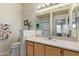 Bathroom featuring vanity with a sink, a toilet, a large mirror and a shower/tub combo at 14950 W Mountain View Blvd # 1112, Surprise, AZ 85374