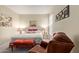 Comfortable bedroom with warm lighting, a seating area, and inviting decor for relaxation at 14950 W Mountain View Blvd # 1112, Surprise, AZ 85374