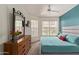 Bright bedroom with a large bed, a wood dresser with decorative mirror and ample natural light at 14950 W Mountain View Blvd # 1112, Surprise, AZ 85374