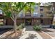 Inviting condo entrance with lush landscaping and a well-maintained walkway creating a warm and welcoming atmosphere at 14950 W Mountain View Blvd # 1112, Surprise, AZ 85374