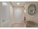 Bright entryway featuring neutral tones, a decorative mirror, and a glimpse into the home's design at 14950 W Mountain View Blvd # 1112, Surprise, AZ 85374