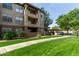 Well-kept condo building featuring lush green grass and convenient parking options for residents and guests at 14950 W Mountain View Blvd # 1112, Surprise, AZ 85374