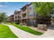 Beautiful condo building with well-maintained landscaping and manicured lawns adding curb appeal at 14950 W Mountain View Blvd # 1112, Surprise, AZ 85374