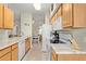 Well-lit kitchen featuring wood cabinets, modern appliances, and a breakfast area with a dining table at 14950 W Mountain View Blvd # 1112, Surprise, AZ 85374
