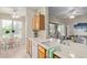 Well-appointed kitchen with a sink and breakfast bar overlooking the living area at 14950 W Mountain View Blvd # 1112, Surprise, AZ 85374