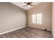 A bright bedroom featuring a ceiling fan, neutral walls, and a window with blinds at 1590 W Desert Broom Dr, Chandler, AZ 85248
