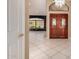 Inviting home foyer with tiled flooring, a modern chandelier, and paneled double doors that enhance the home's aesthetic at 1590 W Desert Broom Dr, Chandler, AZ 85248