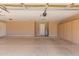 Spacious garage featuring an automatic door, storage cabinets, and access door at 1590 W Desert Broom Dr, Chandler, AZ 85248