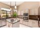 Kitchen with stainless steel appliances, granite countertops, and stylish cabinetry offers both functionality and modern appeal at 1590 W Desert Broom Dr, Chandler, AZ 85248