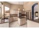 Bright kitchen featuring a center island, stainless steel appliances, tile backsplash and granite countertops at 1590 W Desert Broom Dr, Chandler, AZ 85248