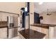 Kitchen boasts stainless steel appliances, granite countertops, center island, and a view of the living area at 1590 W Desert Broom Dr, Chandler, AZ 85248