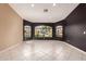 Bright living room boasts elegant tile floors, large windows offering neighborhood views, and two-tone walls at 1590 W Desert Broom Dr, Chandler, AZ 85248