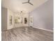 Open-concept living room with modern light fixture, wood-look floors, and large windows for ample natural light at 1590 W Desert Broom Dr, Chandler, AZ 85248