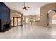 Open living room boasting tile floors, a fireplace, and glass doors that offer views of the pool and backyard at 1590 W Desert Broom Dr, Chandler, AZ 85248