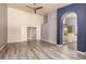 Open living space featuring wood-look floors and an archway leading to the ensuite bathroom at 1590 W Desert Broom Dr, Chandler, AZ 85248