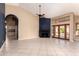 Bright living room featuring tile flooring, a fireplace, and glass doors leading to the backyard and pool area at 1590 W Desert Broom Dr, Chandler, AZ 85248