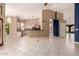 Bright, open-concept living space with tile floors, connecting to the kitchen and featuring views of the backyard at 1590 W Desert Broom Dr, Chandler, AZ 85248
