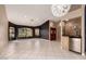 Open living area showcasing tile flooring, a wet bar, stylish lighting, and large windows for natural light at 1590 W Desert Broom Dr, Chandler, AZ 85248